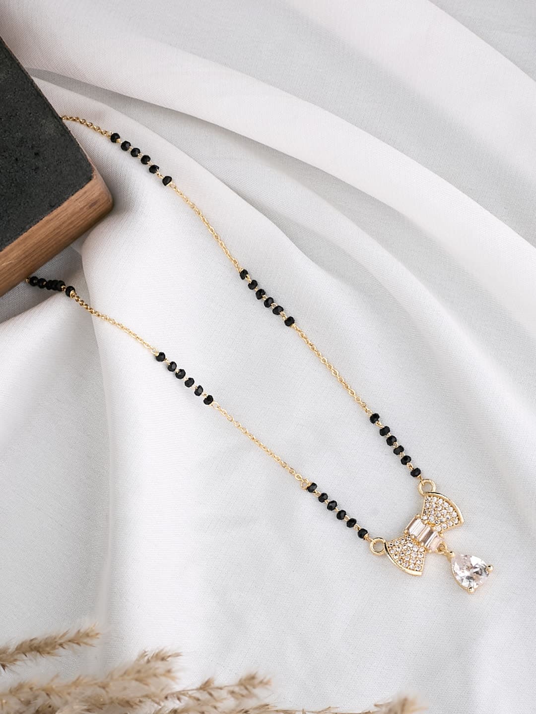 ATIBELLE Gold-Plated Stone Studded & Beaded Bow Shaped Mangalsutra - Image 1